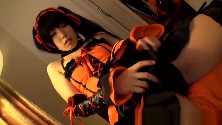 Oriental cosplay babe rubs toy on her pussy